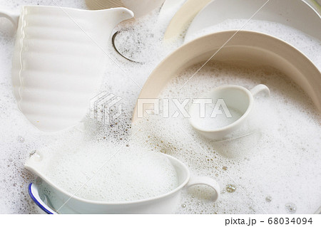 Washing dishes, Close up of utensils soaking in 68034094