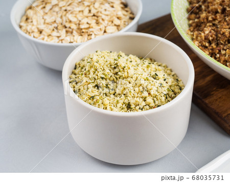 Shelled hemp seeds superfood in white bowl Shelled hemp seeds superfood in white bowl 68035731
