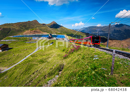 Electric tourist train and mountain lake in background, Grindelwald, Switzerland 68042438