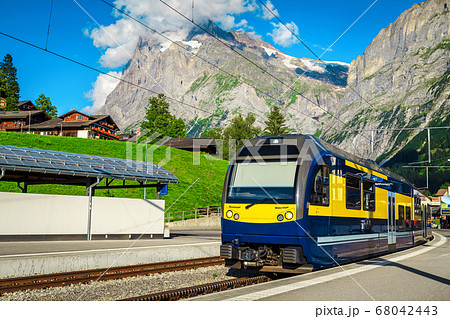 Mountain train station with modern passenger train, Grindelwald, Switzerland 68042443
