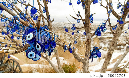 Blue Evil eye charms hang on the tree in Cappadocia, Turkey 68042703