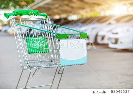 New supermarket trolley on the street and blur of 68043587