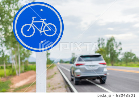 Modern car running on asphalt road / bicycle lane Modern car running on asphalt road / bicycle lane 68043801