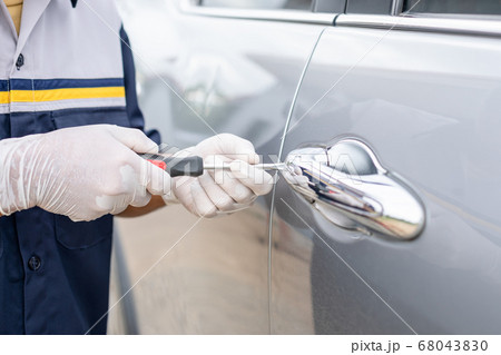 Car technician wearing white gloves and using Car technician wearing white gloves and using 68043830