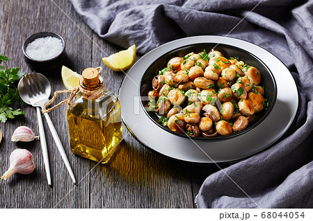 Spanish garlic mushroom tapas al ajillo on a plate Spanish garlic mushroom tapas al ajillo on a plate 68044054