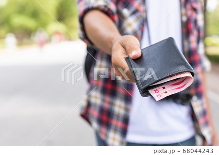 Hand of Asian tourist giving banknote and black 68044243