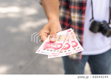 Hand of Asian tourist giving banknote and black 68044244