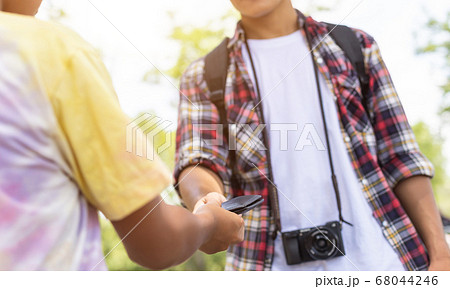 Asian tourist picking up his black wallet from 68044246