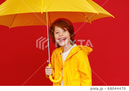Funny boy with umbrella on rainy day. Funny boy with umbrella on rainy day. 68044470