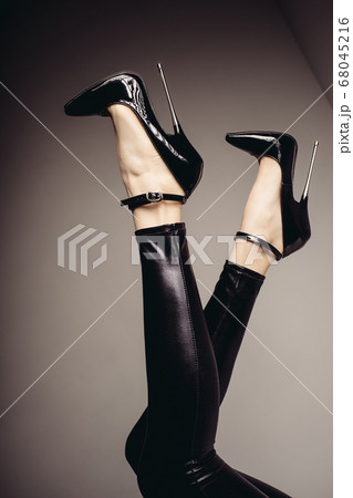 Slender female legs in spandex catsuit and a 68045216