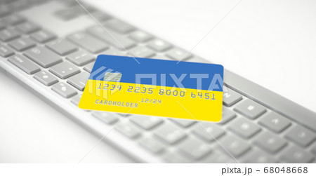 Plastic bank card depicting flag of Ukraine on computer keyboard. Fictional numbers Plastic bank card depicting flag of Ukraine on computer keyboard. Fictional numbers 68048668