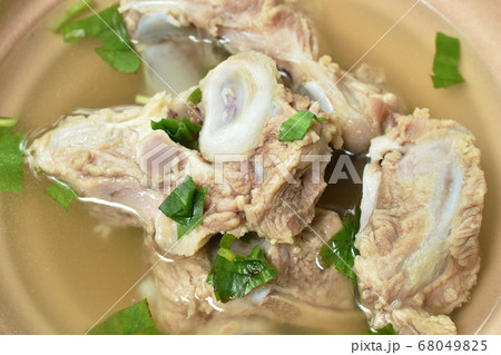 boiled pork bone with Chinese celery soup dipping spicy chili sauce boiled pork bone with Chinese celery soup dipping spicy chili sauce 68049825