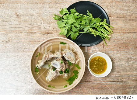 boiled pork bone with Chinese celery soup dipping spicy chili sauce boiled pork bone with Chinese celery soup dipping spicy chili sauce 68049827