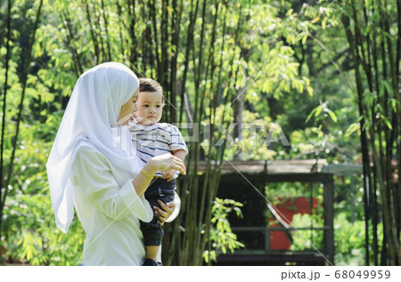 young mother spending time with her son at park during weekend young mother spending time with her son at park during weekend 68049959