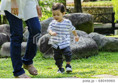 young mother spending time with her son at park during weekend young mother spending time with her son at park during weekend 68049960