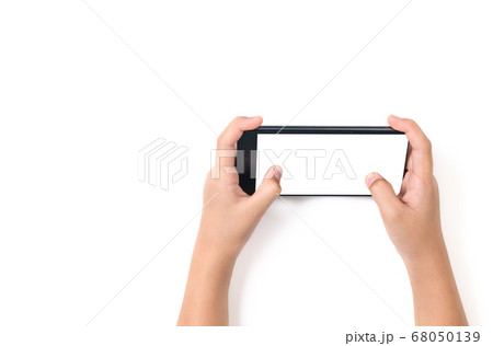 Child hand holding black smartphone with white Child hand holding black smartphone with white 68050139