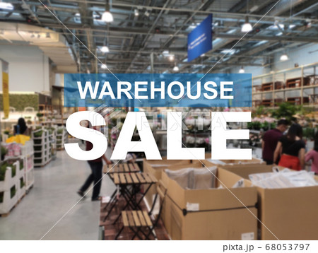 The word WAREHOUSE SALE is clearly written against the background of an image of a department store in a large warehouse. The image has been blurred. 68053797