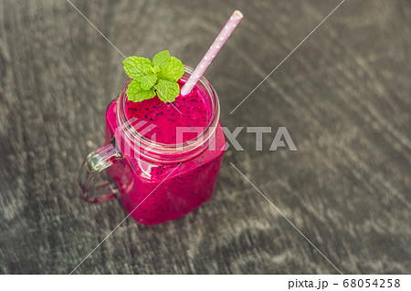 Smoothies of a red organic dragon fruit on an old wooden background 68054258