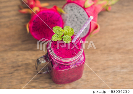 Smoothies of a red organic dragon fruit on an old wooden background 68054259