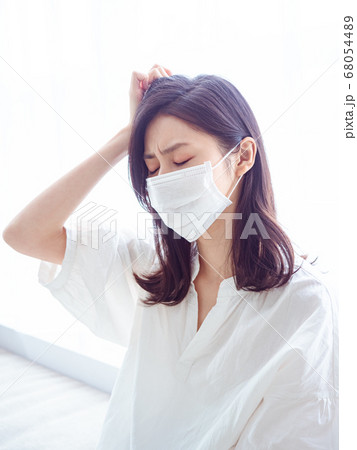 Asian woman having headache on white background Asian woman having headache on white background 68054489