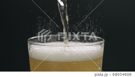 pour cider into glass with zoom out on black background pour cider into glass with zoom out on black background 68054606