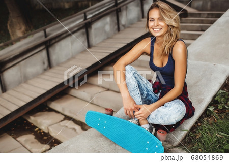 girl posing with skate board 68054869