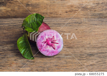 fresh Chrysophyllum cainito fruits on wood background fresh Chrysophyllum cainito fruits on wood background 68055275