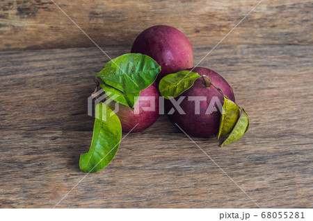 fresh Chrysophyllum cainito fruits on wood background 68055281
