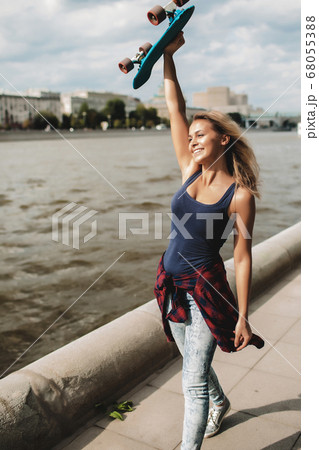 girl posing with skate board girl posing with skate board 68055388