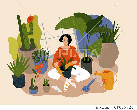 Young woman spend time in a greenhouse or home garden. 68055720