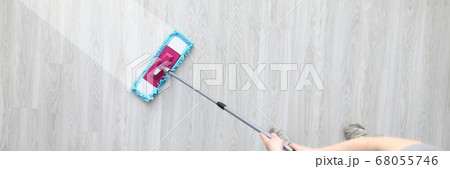Male hant hold plastic mop and wash dirty ploor closeup background Male hant hold plastic mop and wash dirty ploor closeup background 68055746
