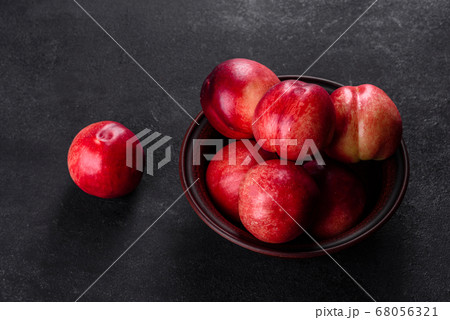 Delicious sweet peaches or nectarines in a brown Delicious sweet peaches or nectarines in a brown 68056321