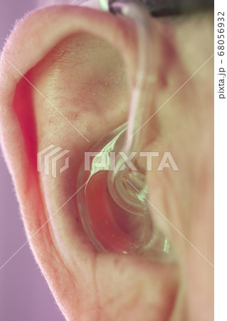 Man with hearing aid 68056932