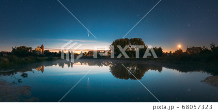 Dobrush, Belarus. Comet Neowise C2020f3 Anf Rising Moon In Night Starry Sky Reflected In Small Lake Waters. 68057323