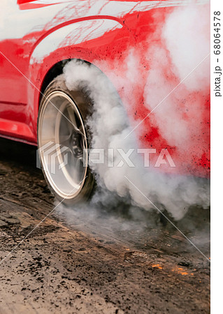 Drag racing car burns rubber off its tires in 68064578