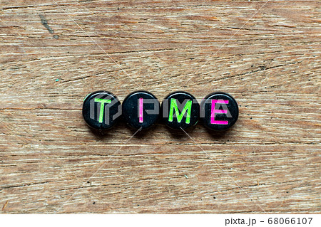 Black bead with color letter in word time on wood background 68066107