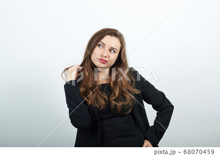 female touching her hair, discontented, angry human 68070459