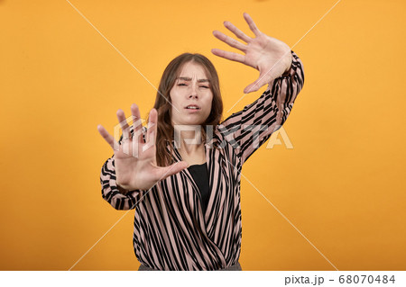 Confused Girl Is Afraid, Pulls Away From Problems. Demonstrates Palms Of Hands. 68070484