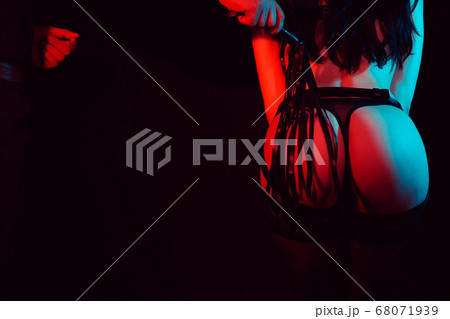 bdsm sex with domination and submission. A man touches a woman's sexy ass with a whip bdsm sex with domination and submission. A man touches a woman's sexy ass with a whip 68071939
