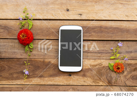mobilie phone with colorful flower zinnia of lifestyle arrangment flat lay syle mobilie phone with colorful flower zinnia of lifestyle arrangment flat lay syle 68074270