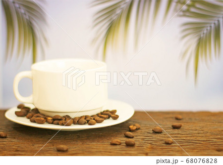 a cup of coffee on wood on blurred palm leaf a cup of coffee on wood on blurred palm leaf 68076828