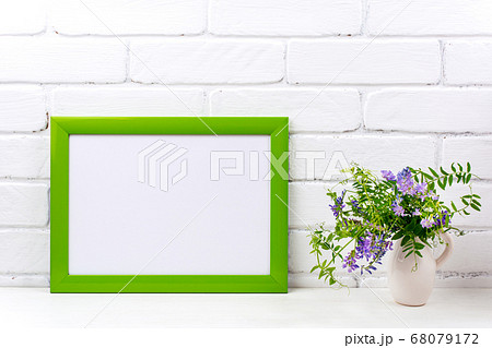 Green landscape frame mockup with purple bird 68079172