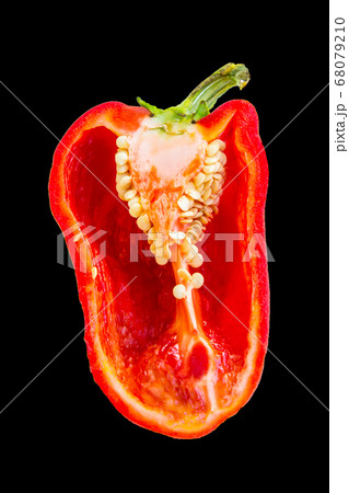 Half a juicy red bell pepper on black background 68079210