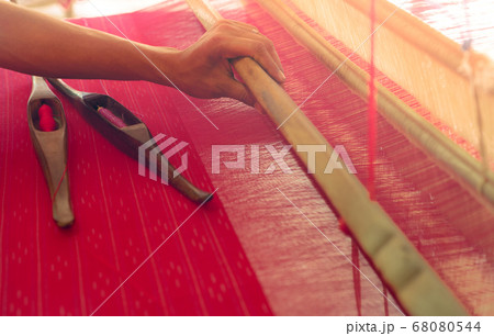 Woman working on weaving machine for weave Woman working on weaving machine for weave 68080544