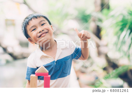 Asian young boy playing wooden block toy on table for creative and development with enjoy. Asian young boy playing wooden block toy on table for creative and development with enjoy. 68081261