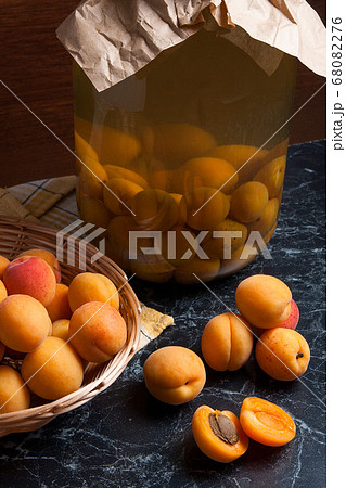 Fresh organic harvested apricots in basket and big 68082276