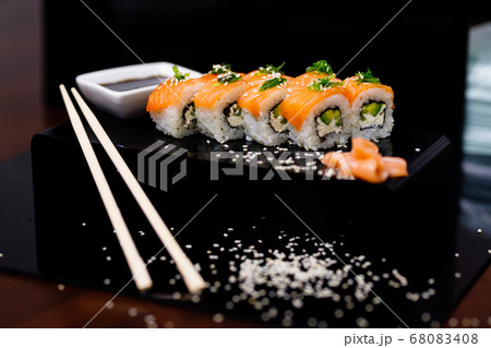 Sushi with salmon. Soy sauce, ginger, red caviar. Roles with red fish. 68083408