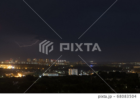 Lightning flashes in the night cloudy sky above the city Lightning flashes in the night cloudy sky above the city 68083504