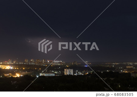 Lightning flashes in the night sky above the city Lightning flashes in the night sky above the city 68083505