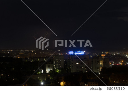 Several lightning bolts strike the ground in the city Several lightning bolts strike the ground in the city 68083510